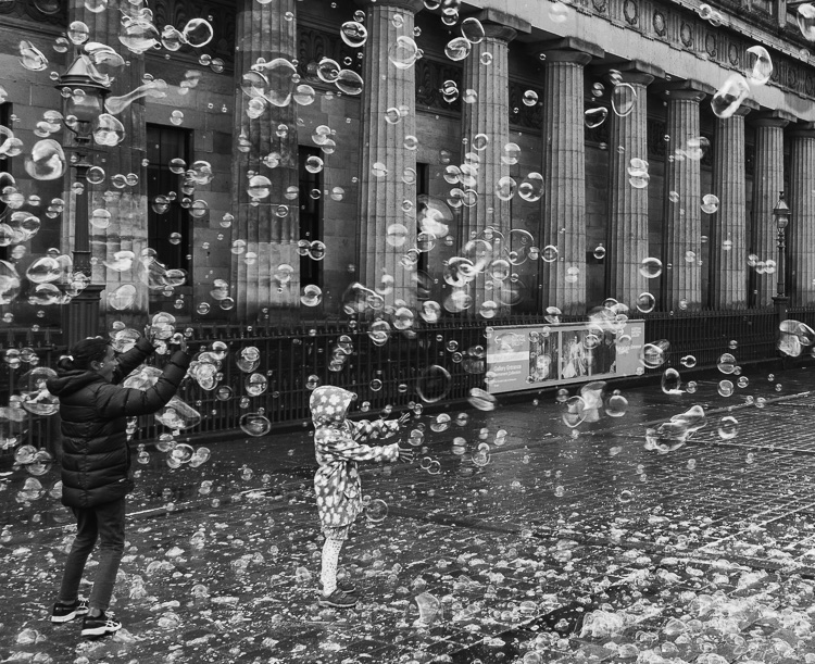 Children Playing with Soap Bubbles